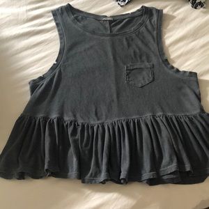 Sleeveless tee with distressed arm holes.